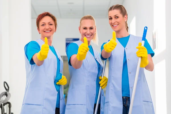 3 cleaning ladies working in a team